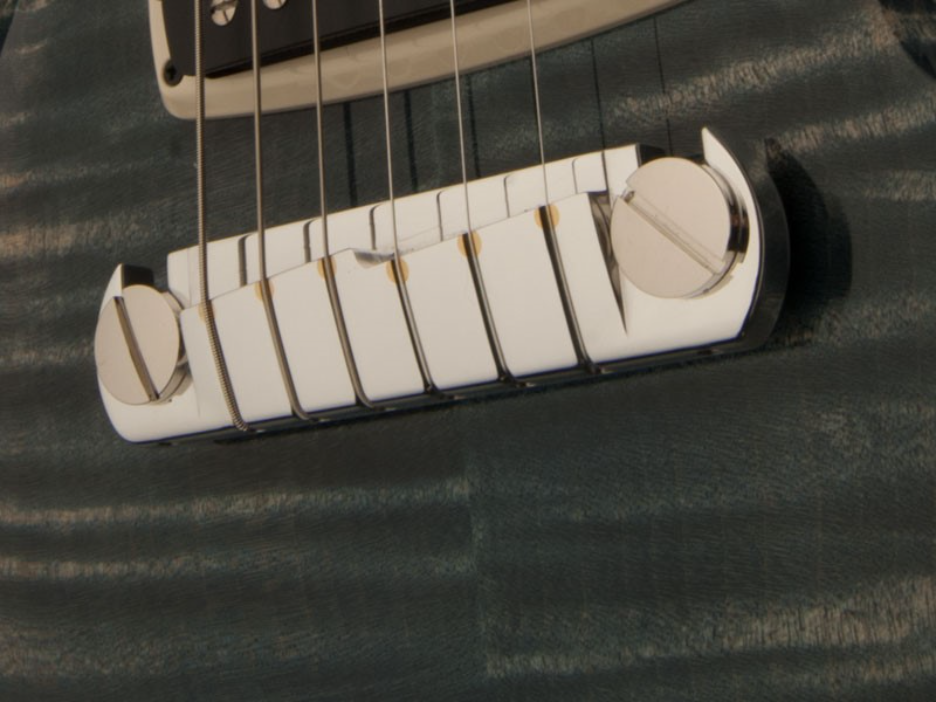 Close-up of a guitar bridge

AI-generated content may be incorrect.